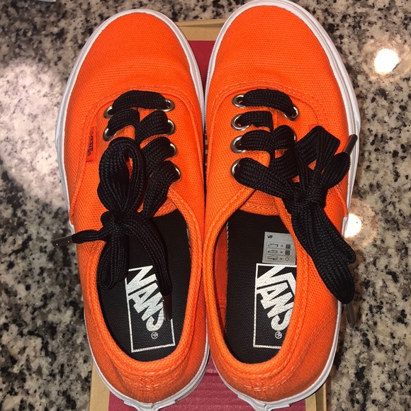orange vans with black laces